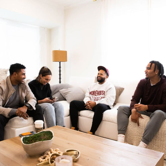 group of people laughing on the sofa 